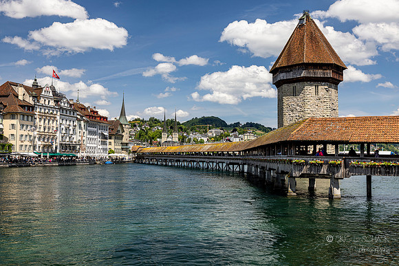 Lucerne: Chapel Bridge and stone tower: View of Lucernes Rathausquai- a scenic promenade along Reuss River